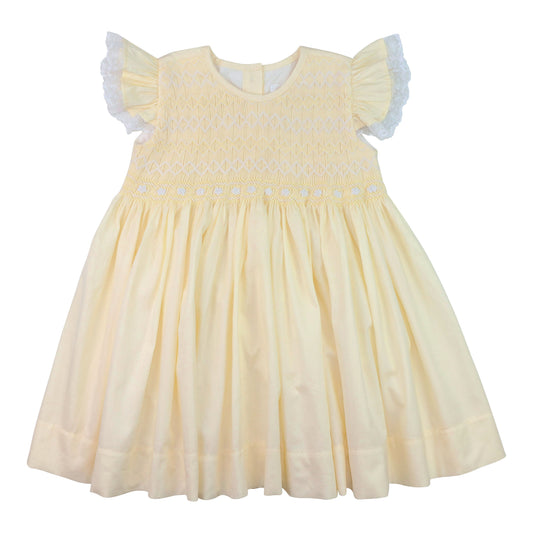 Yellow dress with white lace details on a white background