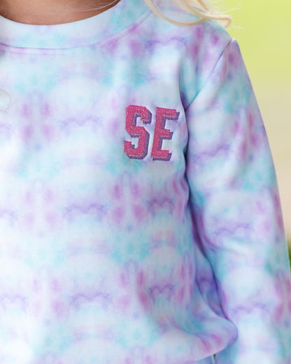 Pastel tie-dye sweatshirt with 'SE' in pink a background