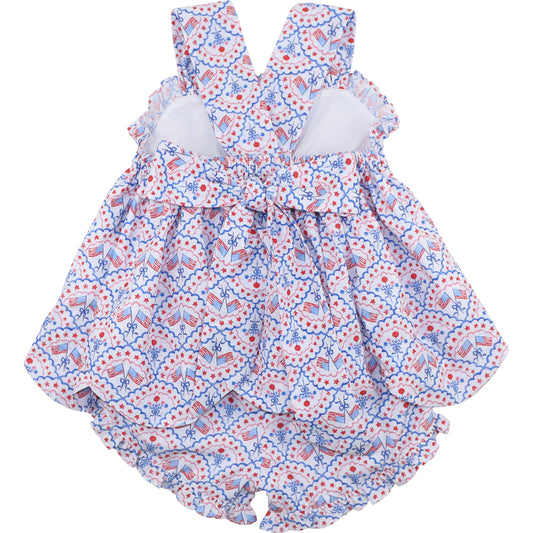 Floral baby romper with ruffled details on a white background