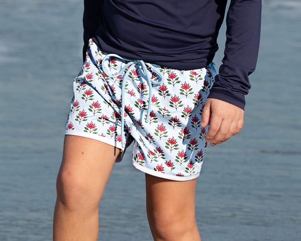 Person wearing floral shorts with a blurred background