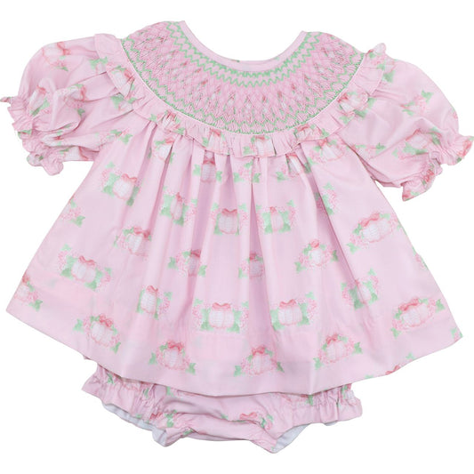 Pink diaper set with ruffles and pumpkin patterns on a white background