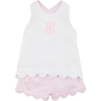White sleeveless top with pink scalloped hem and matching shorts on a white background
