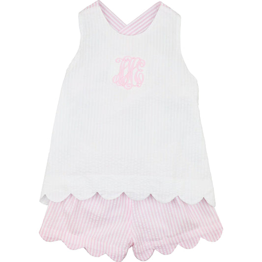 White sleeveless top with pink scalloped hem and matching shorts on a white background