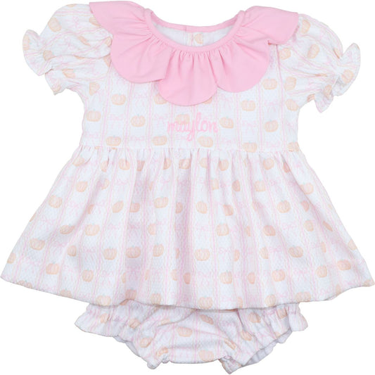Diaper set with pink collar and white pumpkin pattern on a white background