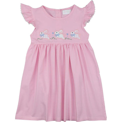 Pink dress with embroidered bunnies on a white background