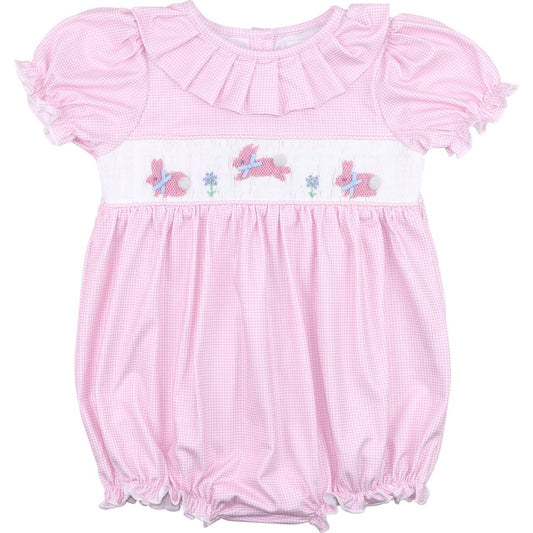 Pink baby romper with ruffled top and embroidered details on a white background