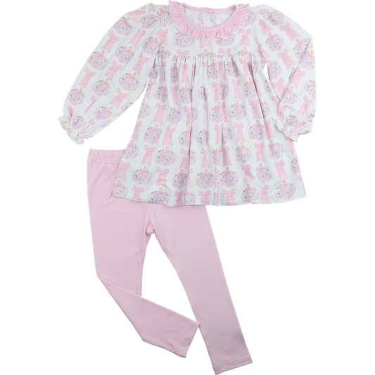 Children's outfit with floral pumpkin top and pink pants on a white background