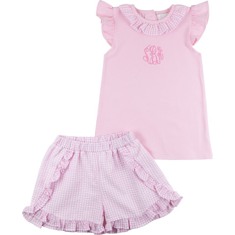 Pink children's outfit with top and shorts on a white background