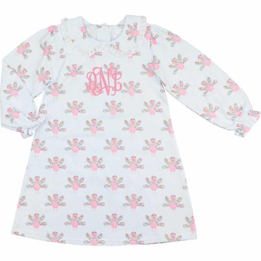 Dress with turkey pattern and monogram "dNl" on a white background