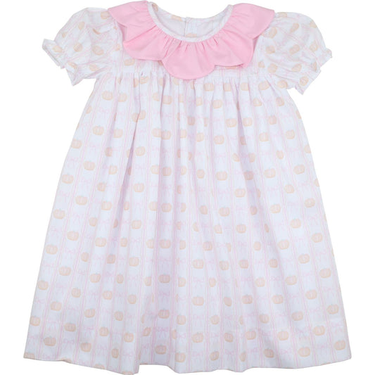 White dress with pink collar and pumpkin pattern on a white background