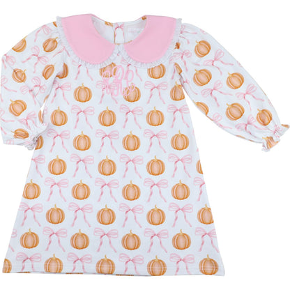 Girl dress with pumpkin and bow pattern on a white background