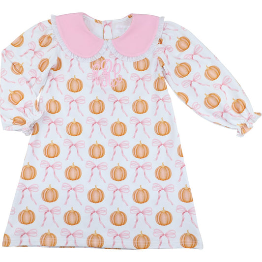 Girl dress with pumpkin and bow pattern on a white background