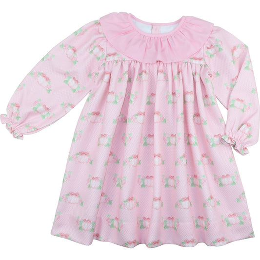 Pink dress with floral and pumpkin pattern on a white background