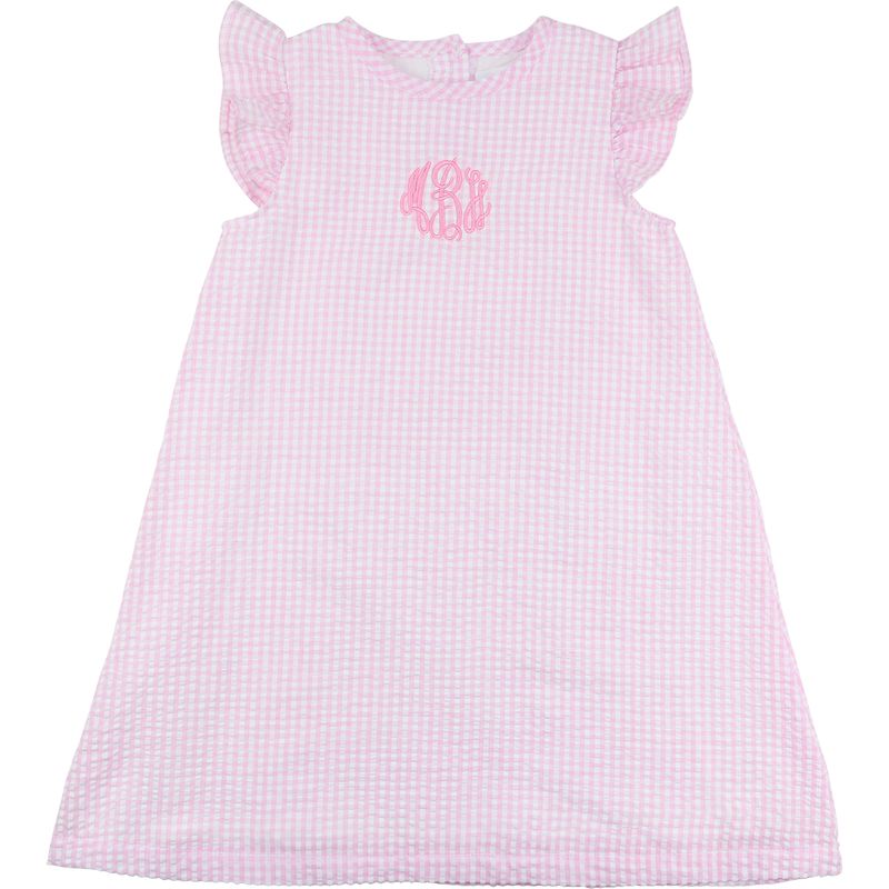 Pink checkered dress with a monogram on a white background