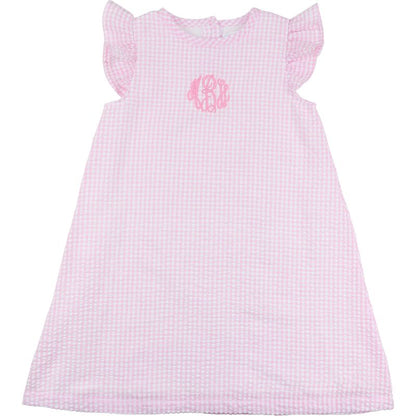 Pink checkered dress with a monogram on a white background