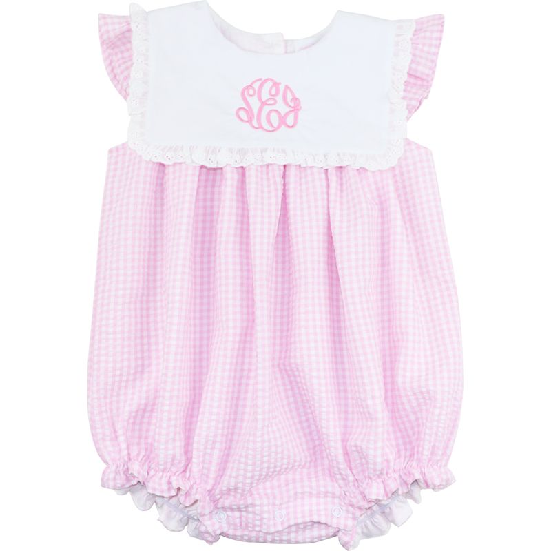 Pink checkered baby romper with white top on a white background