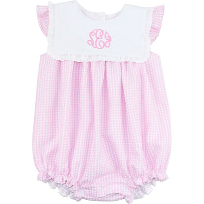 Pink checkered baby romper with white top on a white background