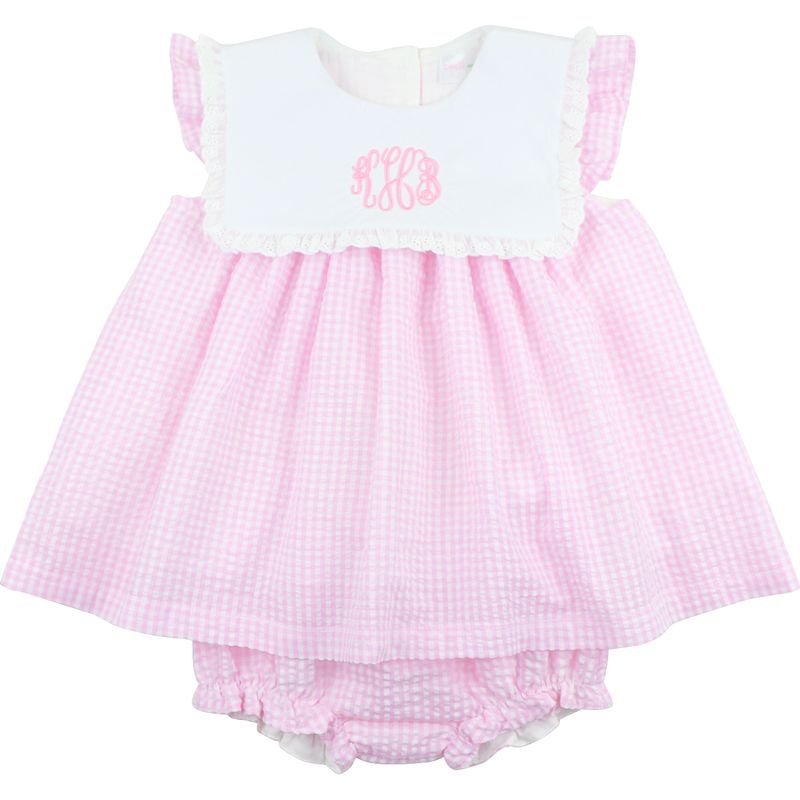 Pink checkered baby dress with white top on a white background