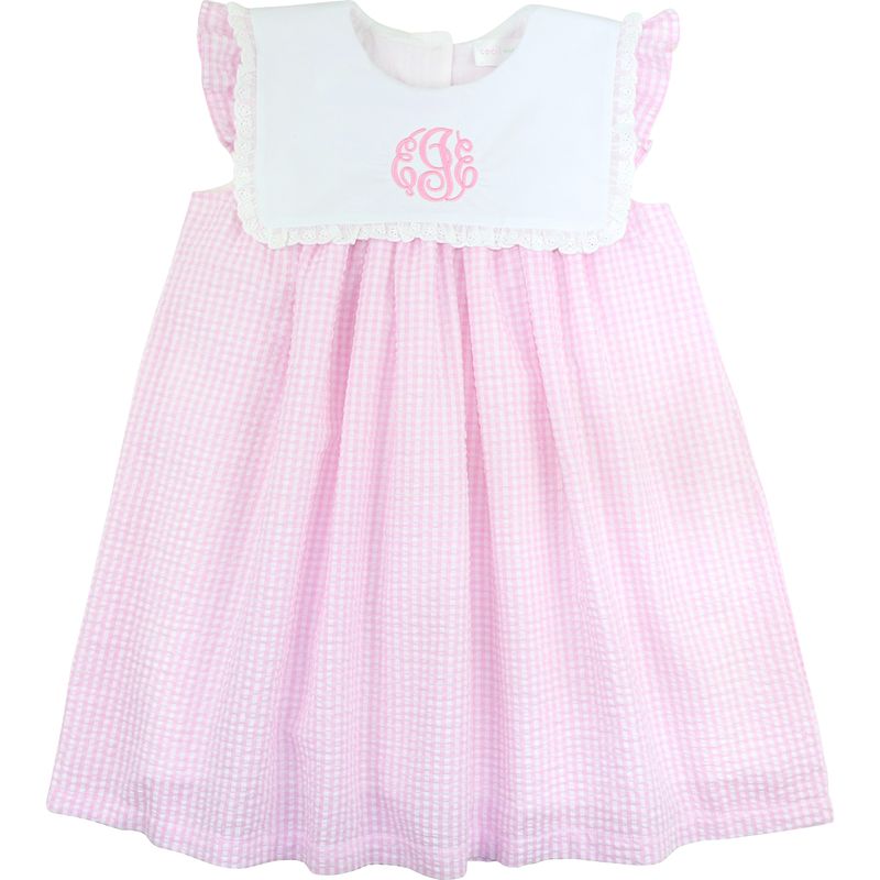 Pink checkered dress with white top on a white background