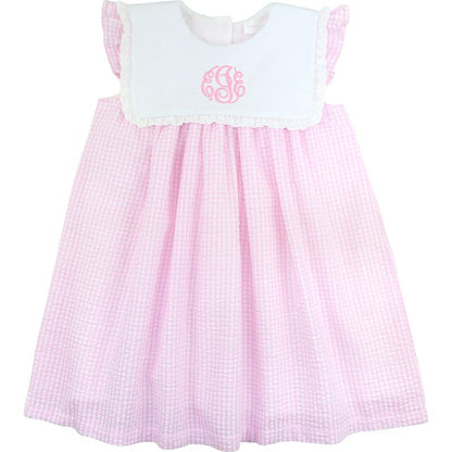 Pink checkered dress with white top on a white background