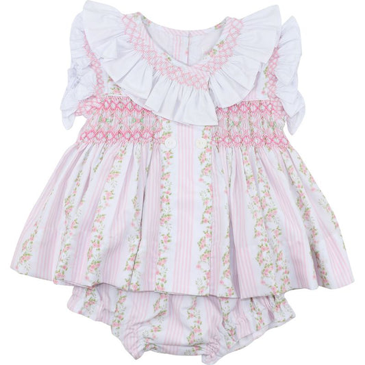 Floral baby dress with ruffled top on a white background