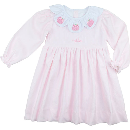 Pink dress with a white collar and pink pumpkins designs on a white background