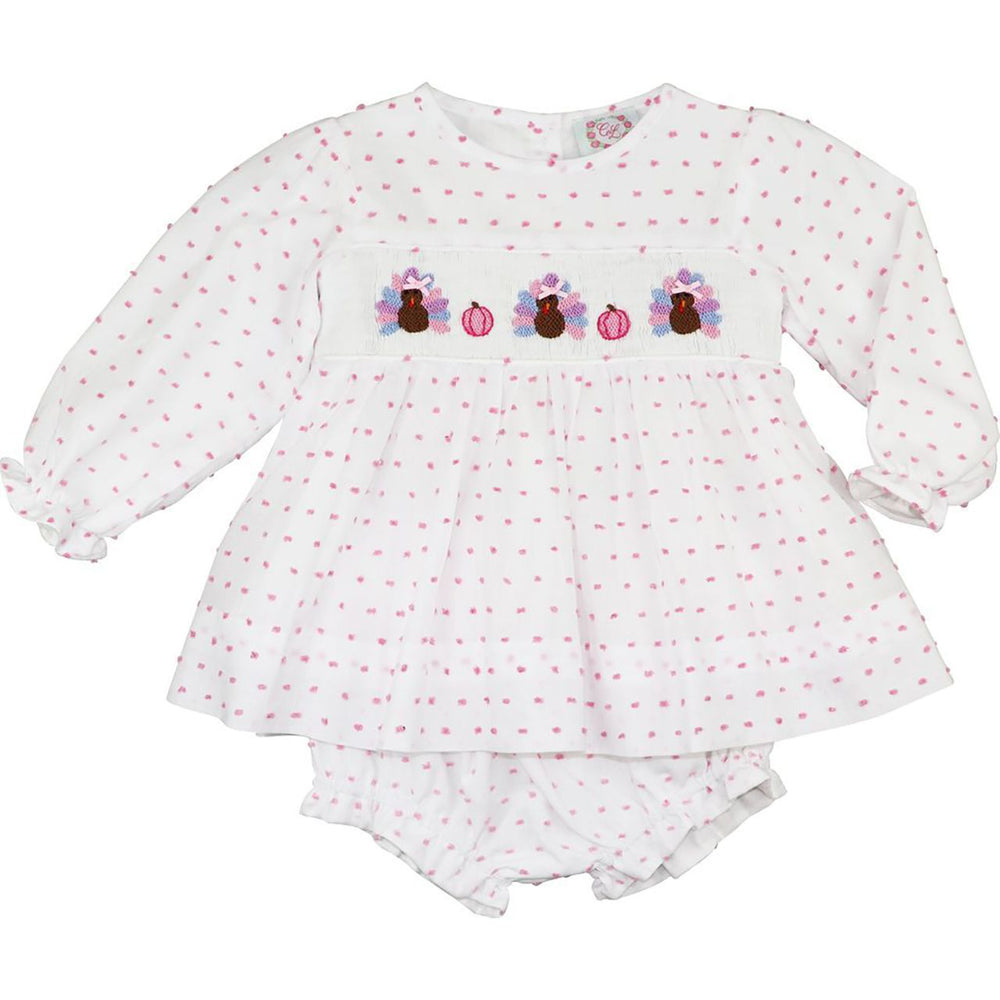 Pink Swiss dot smocked turkey outfit for a toddler girl at Thanksgiving