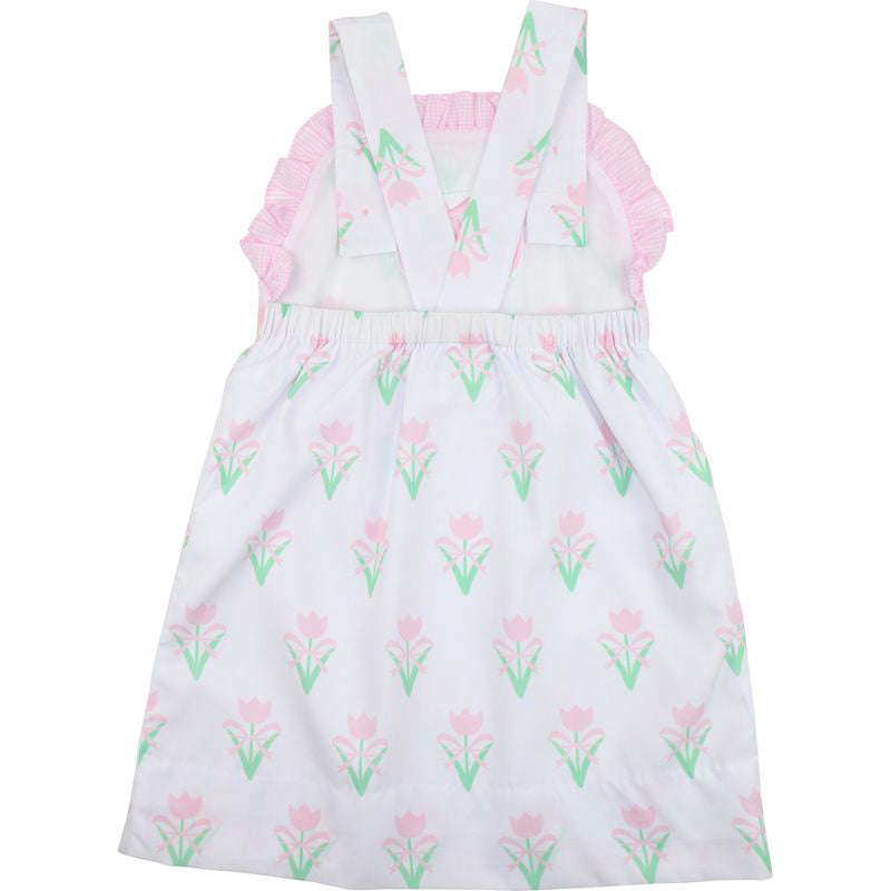 White dress with pink floral pattern on a white background