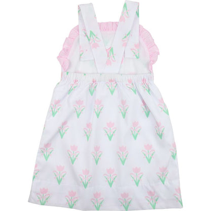 White dress with pink floral pattern on a white background