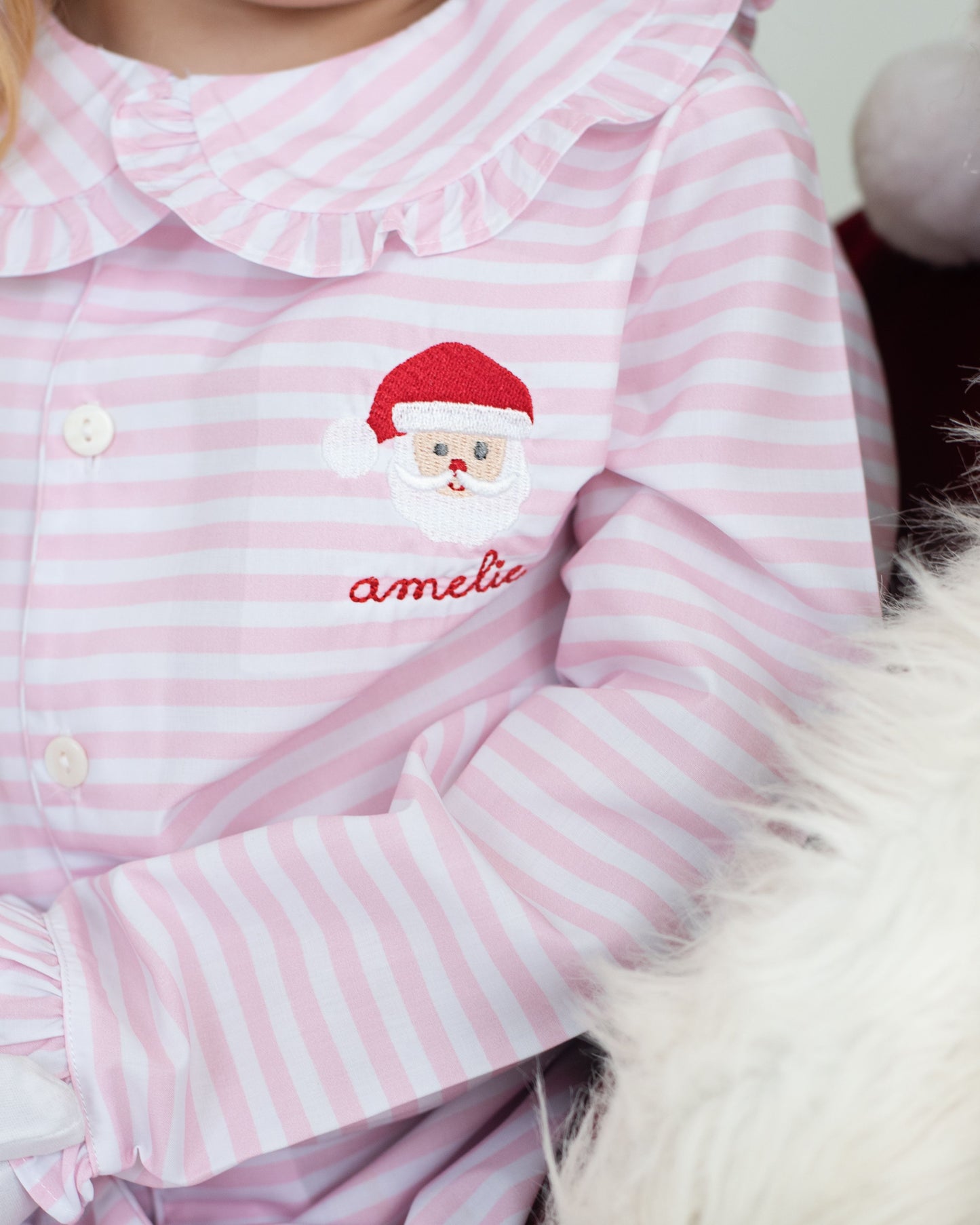 Pink and white striped pajamas with a Santa Claus embroidered and 'amelia' monogram 