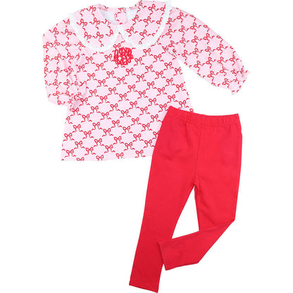 Pink long-sleeve shirt with red bow pattern and red pants on a white background