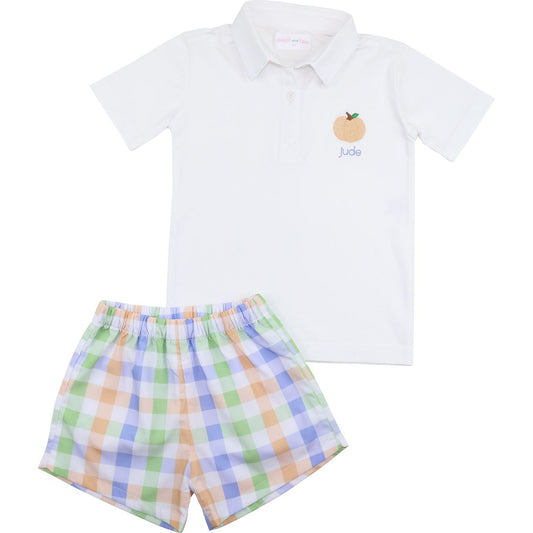 White polo pumpkin shirt with a logo and plaid shorts on a white background