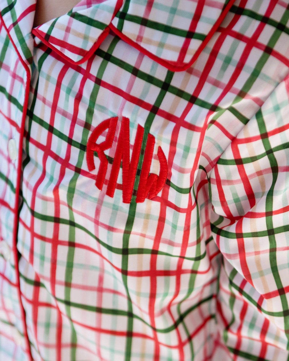 Plaid shirt with red and green lines and 'PML' branding.