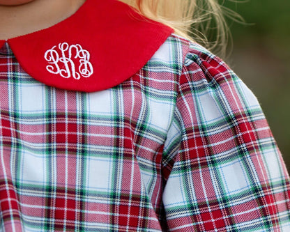 Plaid shirt with red collar and monogram, blurred background