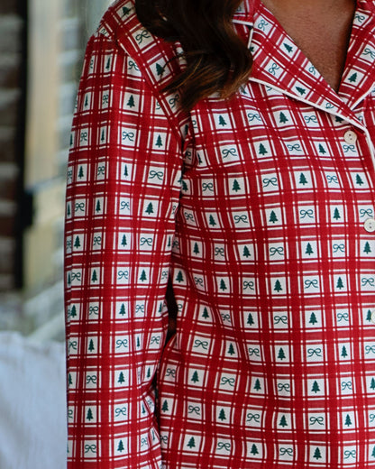 Red checkered shirt with bow and tree pattern worn by a person