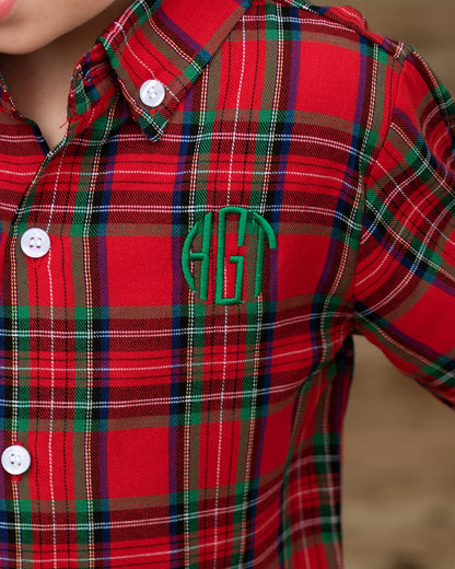 Red plaid shirt with a green monogram on a blurred background