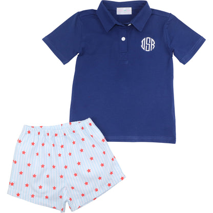 Blue polo shirt with monogram and star-patterned shorts on a white background