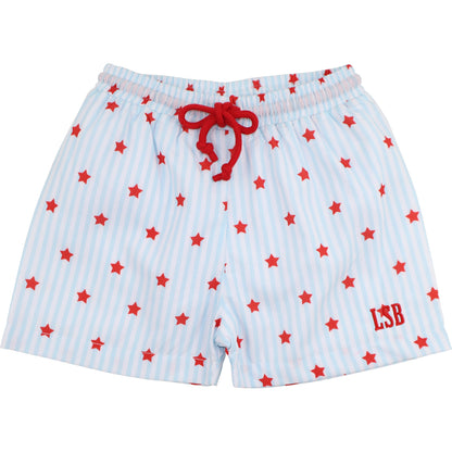 Light blue and white striped boys’ swim trunks with red stars, a red drawstring waist, and red embroidered initials on the lower leg.