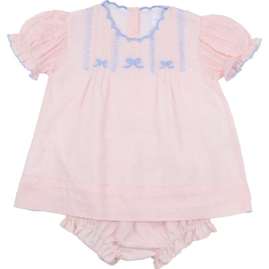 Pink baby outfit with ruffled top and bloomers on a white background