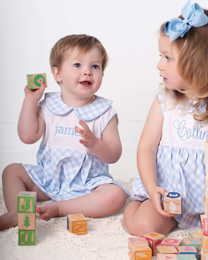 Two children playing with colorful blocks on a white background