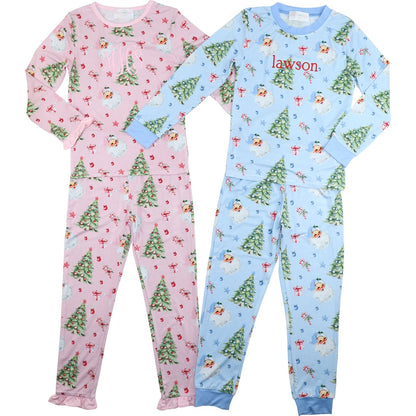 Two children's pajama sets, one pink with Christmas tree pattern and one blue with snowman pattern, on a white background.