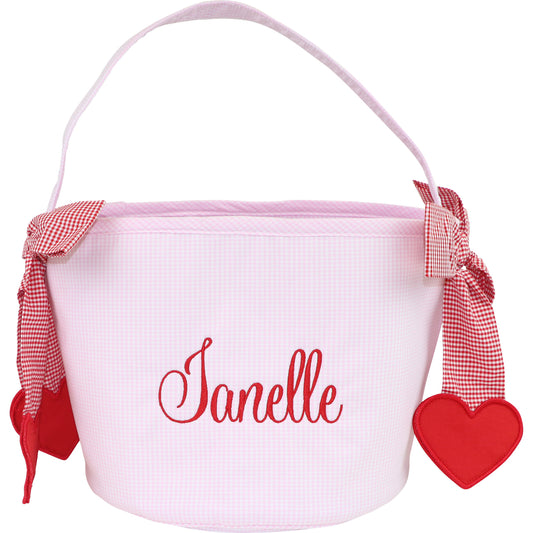 White bucket with red text 'Janelle', red checkered ribbons, and a red heart on a white background