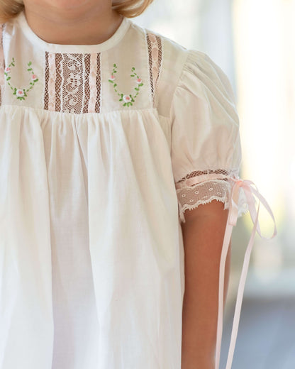 White dress with lace details on a blurred background