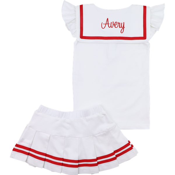 White dress with red trim and 'Avery' monogram, paired with a white skirt with red trim on a white background.