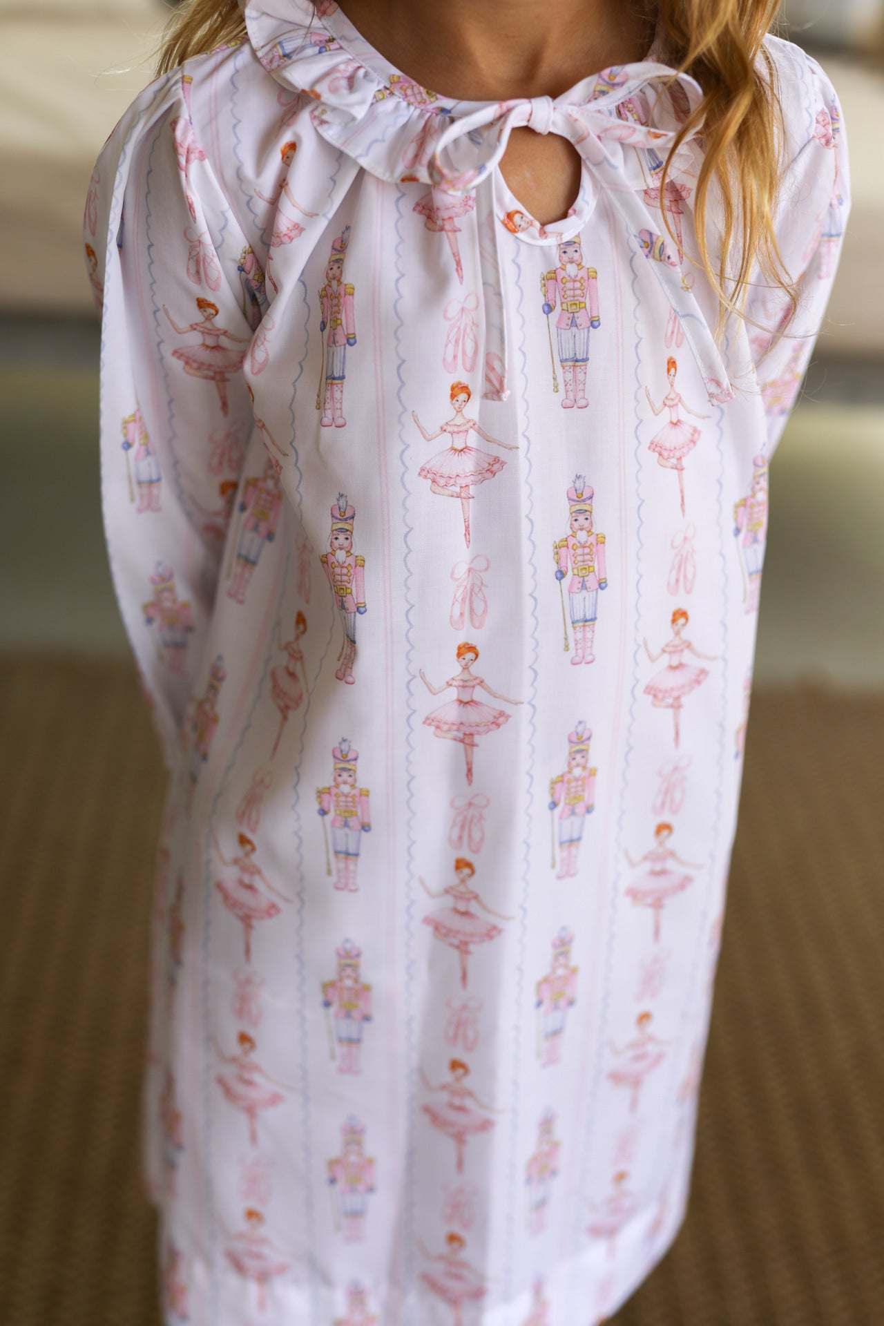 White nightgown with ballet dancer and nutcracker pattern on a blurred background
