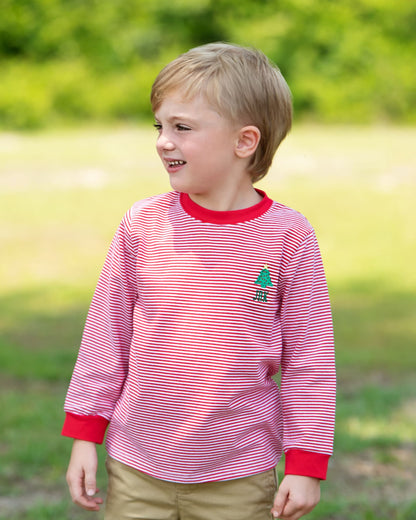 Young boy wearing a red and white striped shirt with a logo outdoors