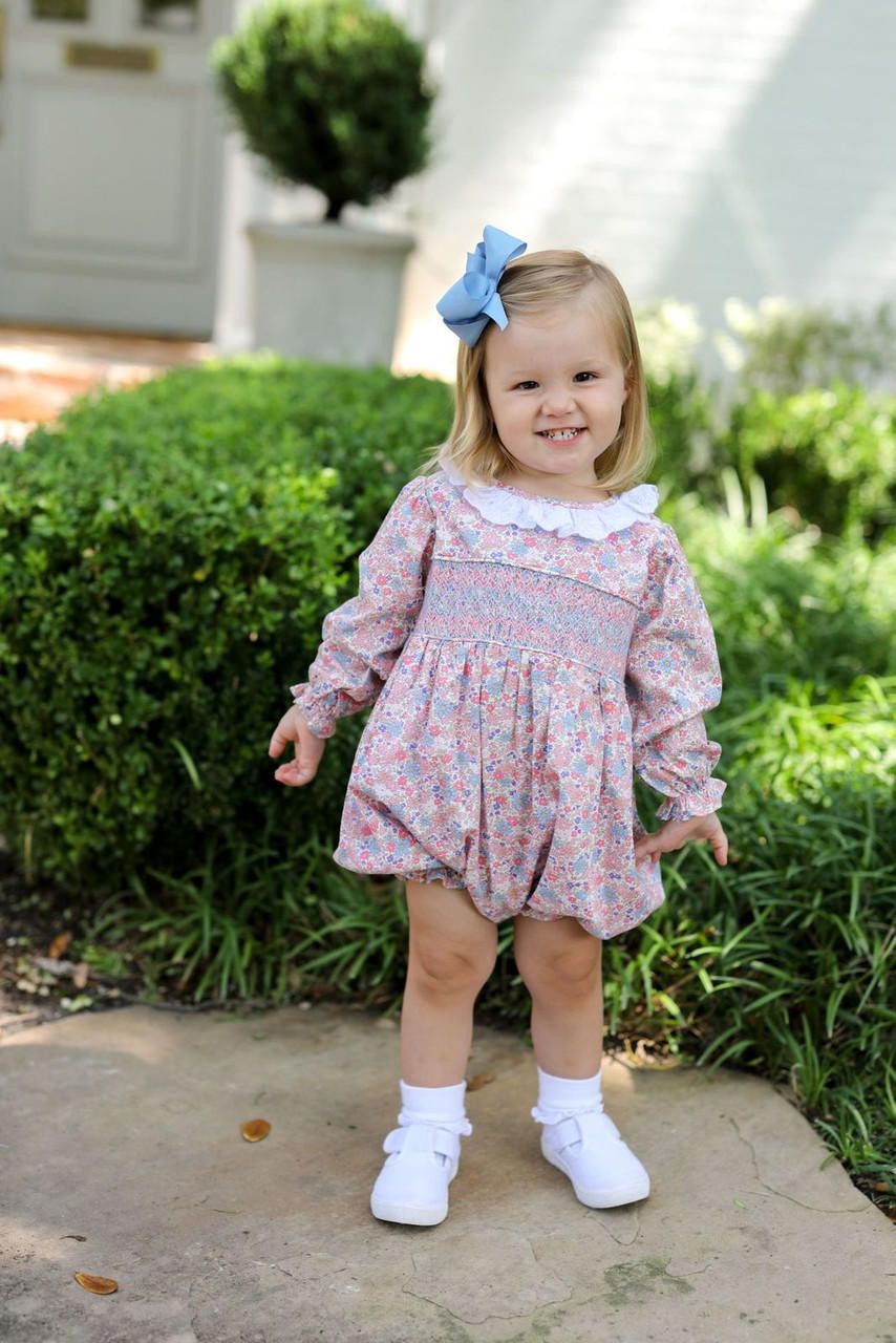 Young girl in a Pink And Blue Floral Smocked Bubble
