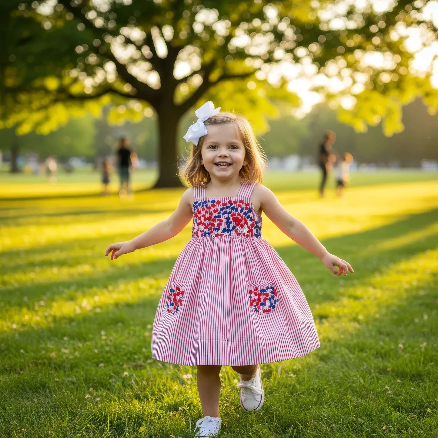 Young girl in a red and white dress with floral patterns running in a park.