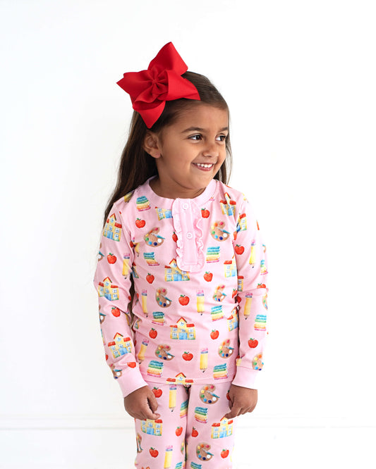 Young girl wearing school themed pajamas. 