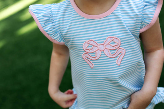 Young Girl Wearing A Blue Stripe Knit Diaper Set With A Pink Applique Bow On The Front